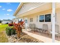Welcoming front porch features comfortable seating and decorative plants, perfect for relaxing and enjoying the outdoors at 17890 Se 96Th Ct, Summerfield, FL 34491