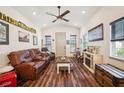 Inviting living room featuring wood floors, comfortable seating, and a cozy fireplace for relaxing evenings at home at 1839 Cr 543A, Sumterville, FL 33585