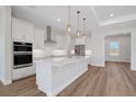Modern kitchen with stainless appliances, white cabinetry, and a center island at 2050 Nw 79Th Loop, Ocala, FL 34475