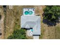 Aerial view showcasing roof, screened pool area, and yard at 2698 Sw 186Th Ct, Dunnellon, FL 34432