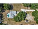 Aerial view of a property with a backyard pool, mature trees, and a large yard at 2698 Sw 186Th Ct, Dunnellon, FL 34432