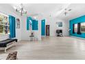 Bright living room with blue accent wall, white trim, light floors and ample natural light at 2698 Sw 186Th Ct, Dunnellon, FL 34432