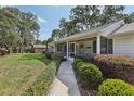 Inviting front porch with beautiful landscaping and a cozy seating area at 36 Gordon Ct, Leesburg, FL 34788