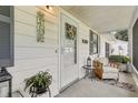 Cozy front porch with a welcoming floral wreath and seating area at 36 Gordon Ct, Leesburg, FL 34788