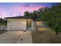 This charming single-story home is bathed in the soft glow of twilight at 361 Oak Lane Drive Dr, Ocala, FL 34472