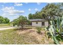 Quaint single-story home surrounded by lush greenery and well-maintained landscaping at 361 Oak Lane Drive Dr, Ocala, FL 34472