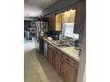 Practical kitchen with stainless steel appliances and abundant counter space near laundry at 3800 Ne 24Th Ct, Ocala, FL 34479