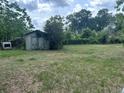Large backyard featuring a weathered shed, perfect for storage or outdoor projects at 3885 Ne 28Th Ter, Ocala, FL 34479