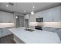 Modern kitchen features an island, stainless steel appliances, and sleek white cabinetry at 5830 Sw 121St Ter, Ocala, FL 34481