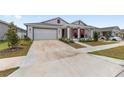 Inviting single-Gathering home with two-car garage, a quaint front porch, and well-maintained lawn at 6486 Sw 75Th Avenue Rd, Ocala, FL 34474