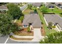 Aerial view of the home showcasing its well-manicured lawn, two-car garage, and position on a corner lot at 6984 Sw 94Th Ct, Ocala, FL 34481