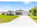 Inviting single-Gathering home with a lush lawn, a two-car garage, and a spacious concrete driveway at 7638 Sw 60Th St, Ocala, FL 34474