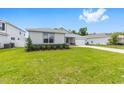 Beautiful single-story home with a green lawn, stone accents, a two-car garage, and tasteful landscaping at 7638 Sw 60Th St, Ocala, FL 34474