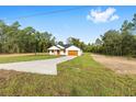 Single-story home on a large lot with a long driveway and a charming covered entryway at 8200 Sw 125Th Court Rd, Dunnellon, FL 34432