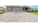 Long driveway features an attractive stone-paved design leading up to the home's attached two car garage at 8465 Sw 101St Ave, Ocala, FL 34481