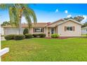 Charming beige home with manicured lawn and landscape, showcasing a cozy and well-maintained exterior at 9131 Se 135Th St, Summerfield, FL 34491