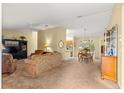 Spacious living room featuring a ceiling fan, comfortable seating, and an open layout for entertaining at 9131 Se 135Th St, Summerfield, FL 34491