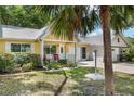 Lovely yellow home with a well-kept lawn, a cozy porch, and mature landscaping at 9290 Sw 89Th Ter # D, Ocala, FL 34481