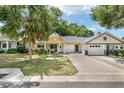 Inviting yellow home with a well-maintained lawn and a quaint front porch at 9290 Sw 89Th Ter # D, Ocala, FL 34481