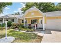 Quaint yellow home featuring a manicured lawn and an inviting front porch at 9290 Sw 89Th Ter # D, Ocala, FL 34481