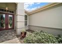 Elegant entryway with double doors, decorative glass, and stone pavers create an inviting welcome at 9459 Se 124Th Loop, Summerfield, FL 34491