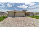 Beautiful single-story home with a three-car garage and a brick driveway at 9813 Sw 105Th Ct, Ocala, FL 34481