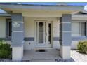 Close up of the covered front entrance, columns and the address on the home at 10269 Sw 63Rd Ave, Ocala, FL 34476