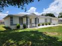 Single story home with a covered front entrance and manicured shrubbery at 10269 Sw 63Rd Ave, Ocala, FL 34476