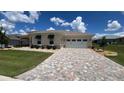 Charming home featuring a brick driveway, a two-car garage and manicured landscaping at 10287 Sw 96Th Ln, Ocala, FL 34481