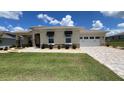 The home has a well manicured front yard and brick accents for a luxurious look at 10287 Sw 96Th Ln, Ocala, FL 34481