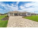 A beautiful single-Gathering home with a manicured lawn and a spacious three-car driveway at 10553 Sw 98Th Pl, Ocala, FL 34481
