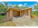 Exterior shot of single story home with carport, front door and partial lawn at 1322 Ne 53Rd St, Ocala, FL 34479
