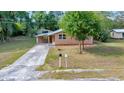 Charming single-story home with a covered carport and a well-maintained lawn at 1322 Ne 53Rd St, Ocala, FL 34479