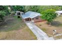 Charming single-story home with a well-maintained lawn, a long driveway, and mature landscaping at 1322 Ne 53Rd St, Ocala, FL 34479