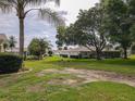 Backyard with mature trees, green lawn, and privacy, creating a park-like setting at 13863 Se 85Th Cir, Summerfield, FL 34491