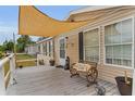 Cozy front porch with outdoor furniture and decor, creating a welcoming entryway at 14276 Se 61St Ave, Summerfield, FL 34491