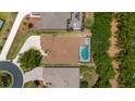 An aerial view shows a home with a screened pool, a paved driveway, and mature landscaping at 1429 Sw 160Th Ln, Ocala, FL 34473