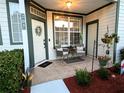 Close-up of a welcoming front porch with seating, plants, and a decorative wreath on the door at 231 Ne 28Th Ave # 207, Ocala, FL 34470