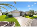 Attractive single-story home boasts a two-car garage, and a beautifully landscaped lawn at 3141 Roswell Rd, The Villages, FL 32162