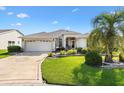 Inviting single-story home with a manicured front yard and a convenient two-car garage at 3141 Roswell Rd, The Villages, FL 32162