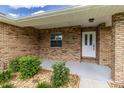 Charming front porch with brick siding, and a well-maintained garden bed at 3295 Se 56 Ave, Ocala, FL 34480