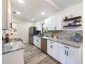 Modern kitchen featuring stainless steel appliances, granite countertops, and white cabinetry at 346 Emerald Rd, Ocala, FL 34472