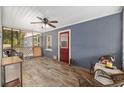 Inviting screened porch with comfortable wicker furniture and wood-look flooring at 3823 Se 49Th St, Ocala, FL 34480