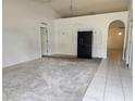 Bright living room with carpeted floors, arched doorways, and natural light creating a cozy atmosphere at 4460 Sw 44Th St, Ocala, FL 34474