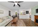 Open-concept living room with wood floors, neutral decor, and seamless flow into the kitchen and dining space at 4601 Se 18Th Ave, Ocala, FL 34480