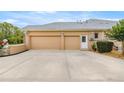Two-car garage with spacious driveway and lush landscaping on a sunny day at 6573 S Magnolia Ave, Ocala, FL 34471