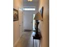 Inviting foyer with a decorative table, tiled floors, and a front door with sidelight windows at 6836 Sw 179Th Court Rd, Dunnellon, FL 34432