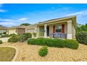 Inviting home exterior with a cozy front porch sitting area and colorful landscaping at 7917 Sw 85Th Loop, Ocala, FL 34476
