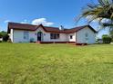 Charming single story home with a well-manicured lawn and vibrant, healthy plants at 8770 Sw 196Th Terrace Rd, Dunnellon, FL 34432