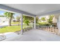 Spacious covered porch offering a pleasant view of the landscaped front yard and neighborhood at 8885 Sw 90Th Ave, Ocala, FL 34481